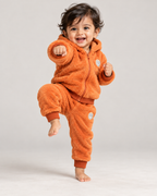 Toddler in a playful kung fu pose wearing the Orange set (illustrative image)